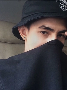 Close-up of black star stud earring in S925 silver on model with streetwear style