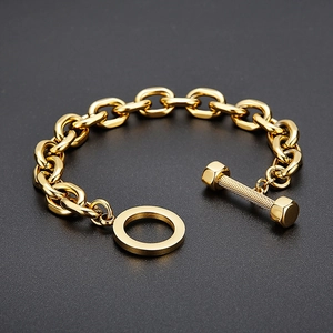 Macro detail of golden dumbbell toggle clasp and thick stainless steel link chain