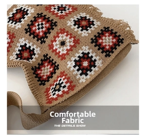 Detail of khaki knitted tote bag with red and black geometric diamond pattern and fringes