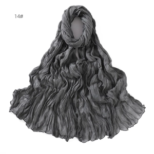Detail showing deep grey crinkled breathable linen-cotton scarf with soft texture