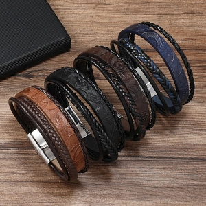 Close-up of multi-layer leather bracelets showing braided textures and metal magnetic clasps