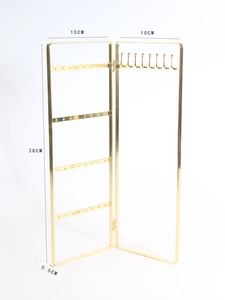 Detail of golden metal jewelry rack showing 28cm height and earring hole structure