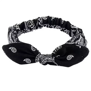 Elastic paisley headband with rabbit ear knot bow in black and white on white background