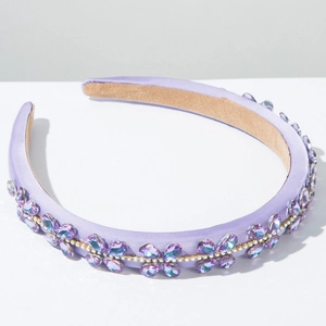 Detail of lavender satin headband with crystal flower patterns and rhinestone chain