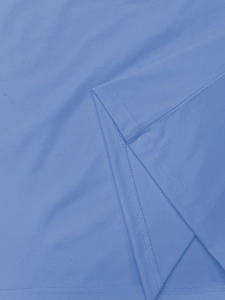 Detail shot of blue cotton fabric with high-quality double-needle stitching on the hem