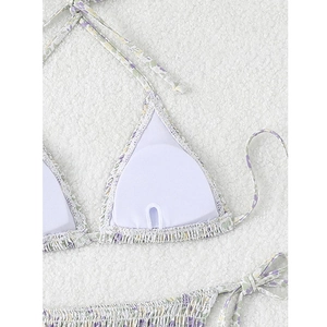 Detail view of the floral bikini top showing white breathable lining and padding inserts