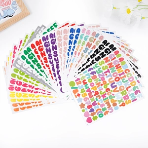 Macro shot of colorful alphabet stickers stacked for DIY scrapbooking decoration