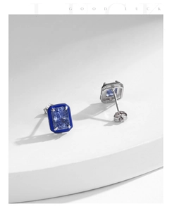 Detailed macro shot of S925 sterling silver earrings with blue stones and hallmarks