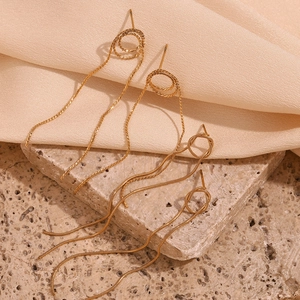 Detail of 18K gold-plated snake chain tassel earrings with woven texture and long fringes