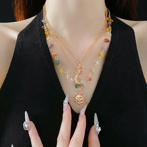 Three-layer gold necklace set featuring celestial sun moon star charms and colorful stones