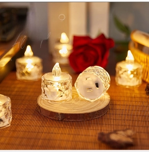 Detail of crystal iceberg LED candle light on wooden coaster with warm ambient glow