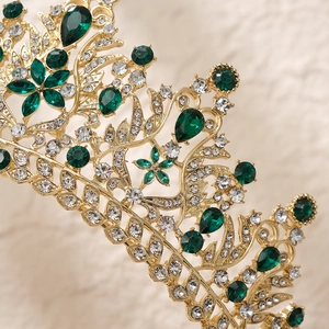 Luxury gold bridal crown featuring vintage green crystals and floral rhinestone details
