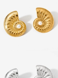Detailed view of conch shell earrings featuring sparkling crystals and white pearls