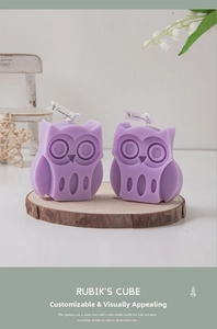 Macro shot of two purple owl-shaped scented candles on a wooden tray for home decor