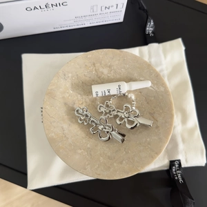 Barrettes à fleurs creuses argentées avec strass sur un plateau en marbre pour femme