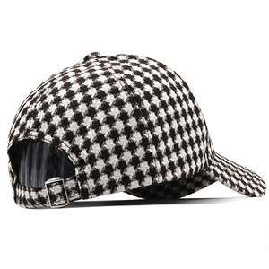 Classic houndstooth baseball cap with black and white texture and adjustable silver buckle