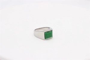 Macro view of a square green gemstone inlay on a vintage silver titanium steel ring