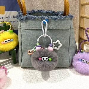 Colorful plush coal ball monster keychains with letter beads on denim bag accessory