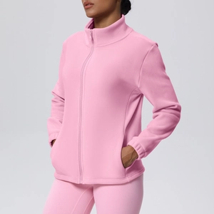Detail of pink fleece sports jacket featuring high collar zip-up and warm texture