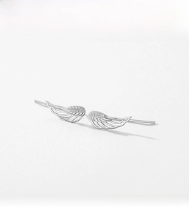 Detailed view of silver angel wing earrings with shimmering white cubic zirconia pave setting