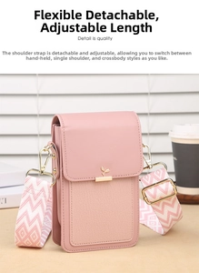 Pink leather phone bag with patterned wide strap and gold leaf logo in lifestyle setting