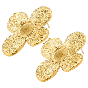 Detailed macro view of gold-tone stainless steel stud earrings with textured flower design