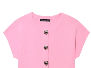 Close-up of pink knit cardigan featuring three silver heart-shaped metal buttons
