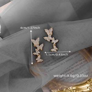 Detailed size view of sparkling golden butterfly drop earrings with white zircons