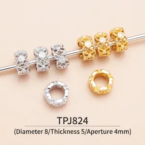 Macro shot of 8mm hollow brass spacer beads with cubic zirconia for DIY jewelry