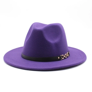 Detail of deep purple wool fedora hat featuring a black belt strap and gold chain buckle