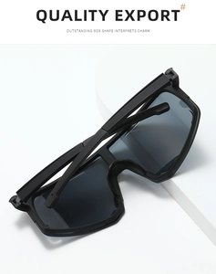 Macro view of large black frame cycling sunglasses with gray polarized lenses on display