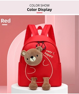 Detail view of the red nylon preschool backpack with a 3D plush bear and gold embroidery