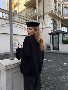Outdoor street style view of black crewneck sweatshirt with vintage letter print