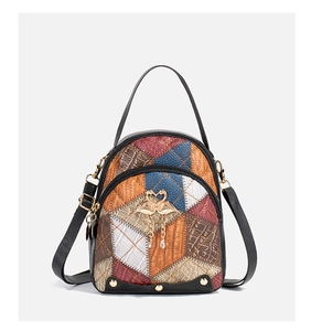 Detail of color-block mini backpack with crocodile texture and golden swan charm