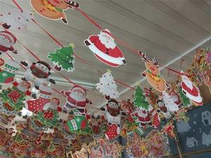 Detail showing hanging Christmas paper banners with Santa, reindeer and snowman designs