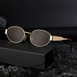 Retro round metal sunglasses with brown lenses on black rock base in high contrast view