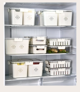 Detailed scene of multi-size white and clear PET storage bins inside a refrigerator