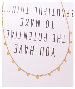 Close-up of gold choker necklace with multiple small heart charms on 18k gold plated chain