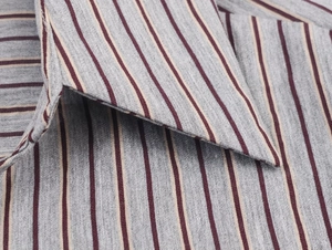 Close-up of the grey striped shirt collar with fine stitching and fabric texture detail