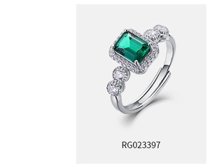 Macro detail of silver S925 ring with oval emerald gemstone and adjustable open band