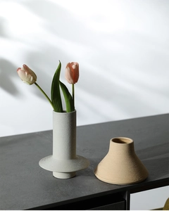 Detail of minimalist ceramic vases with brushed texture and tulip flower decoration