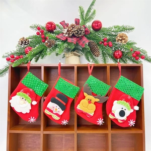 Set of 4 Christmas stockings with Santa, Snowman, Reindeer, and Bear hanging on wood