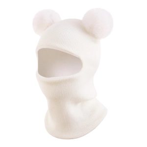 Detail of white knit baby balaclava featuring fluffy faux fur pom-poms and ribbed texture