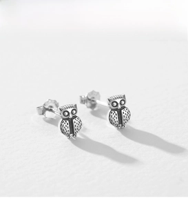 Macro shot of 925 sterling silver owl stud earrings with detailed feather texture