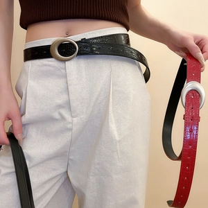 Detail showing vintage crocodile leather texture belts with matte silver buckles