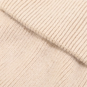 Macro view of ribbed knit angora wool fabric showing soft texture and oatmeal color