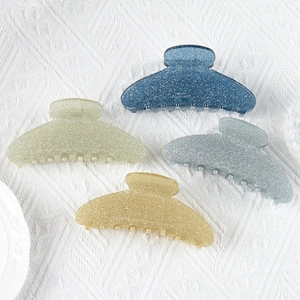 Set of four large glitter acrylic shark hair clips in blue, green, gold and grey colors