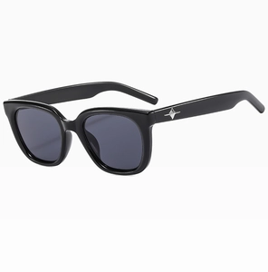 Side view of black square sunglasses featuring a silver star detail on the thick temples