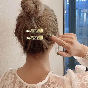 Pair of gold metal butterfly hair clips with sparkling stars and rhinestones for women