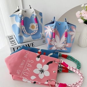 Elegant floral knit tote bag with knotted handles available in three stylish colors